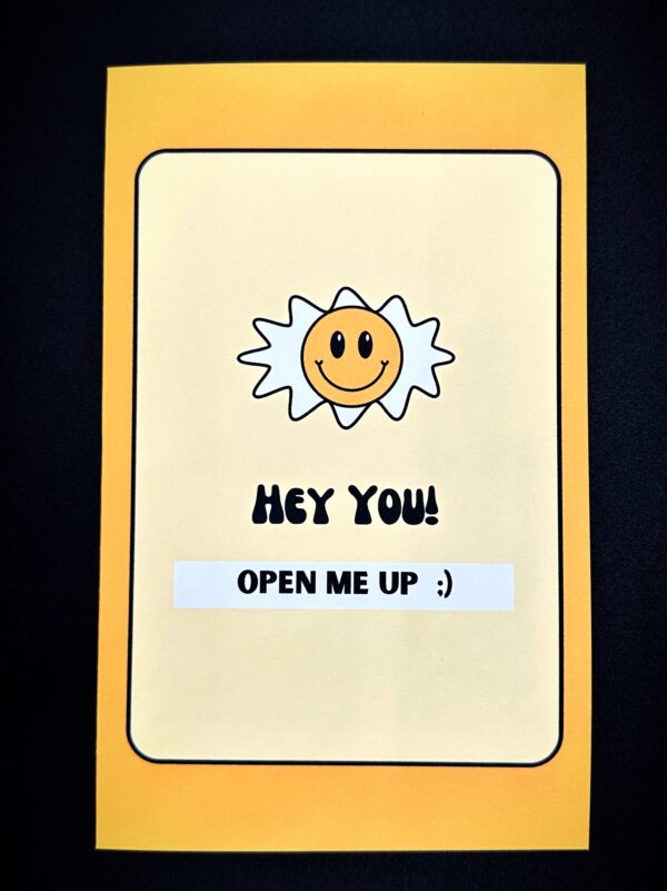 Yellow card with smiley sun and text.