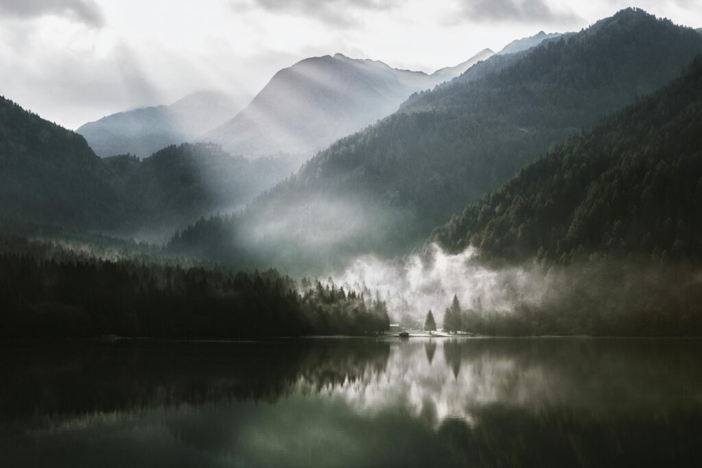 Misty mountain lake with reflection.