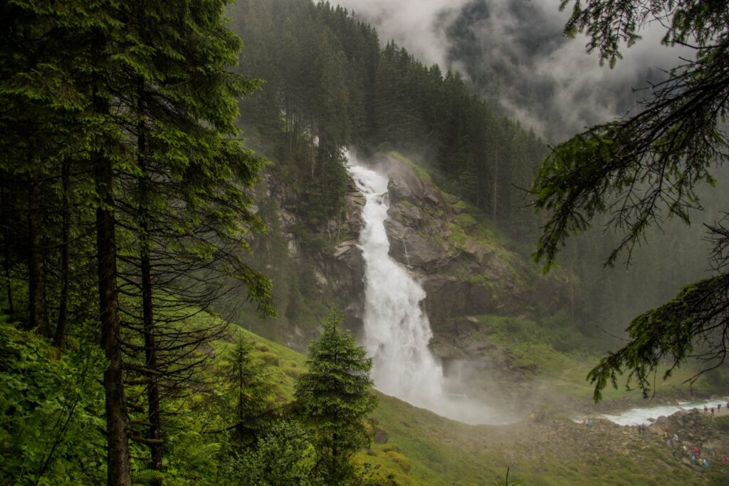 Waterfall cascading down a misty mountainside.